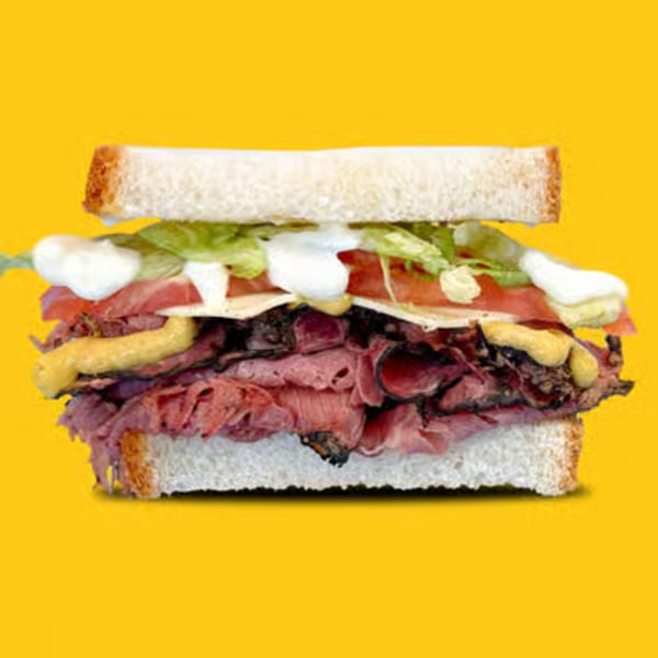 Jay's Deli roast beef sandwich with lettuce, tomato, cheese, mustard, and mayonnaise on white bread.