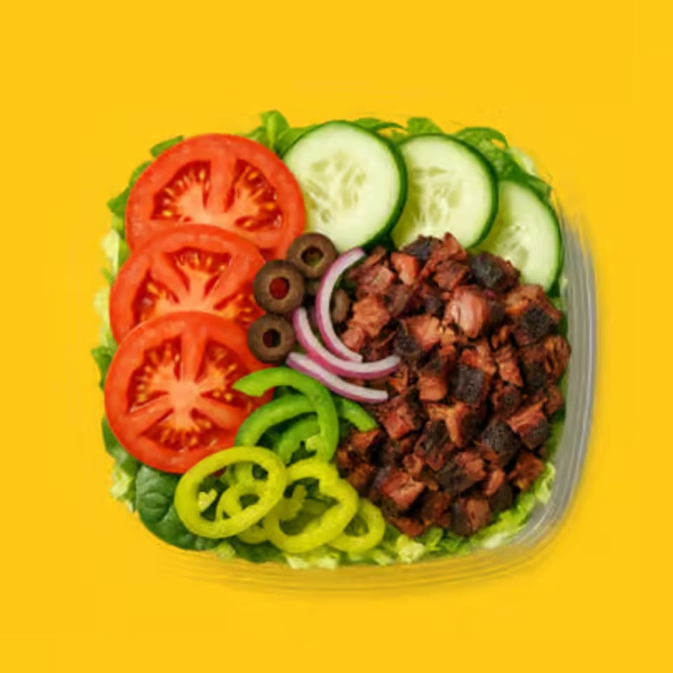Jay's Deli salad with diced meat, tomatoes, cucumbers, olives, red onion, and green peppers.